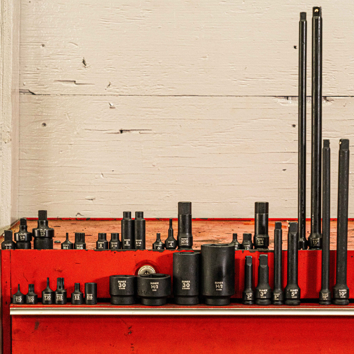 A wide assortment of SUNEX Impact Sockets representing Mechanics Tools on a toolbox.
