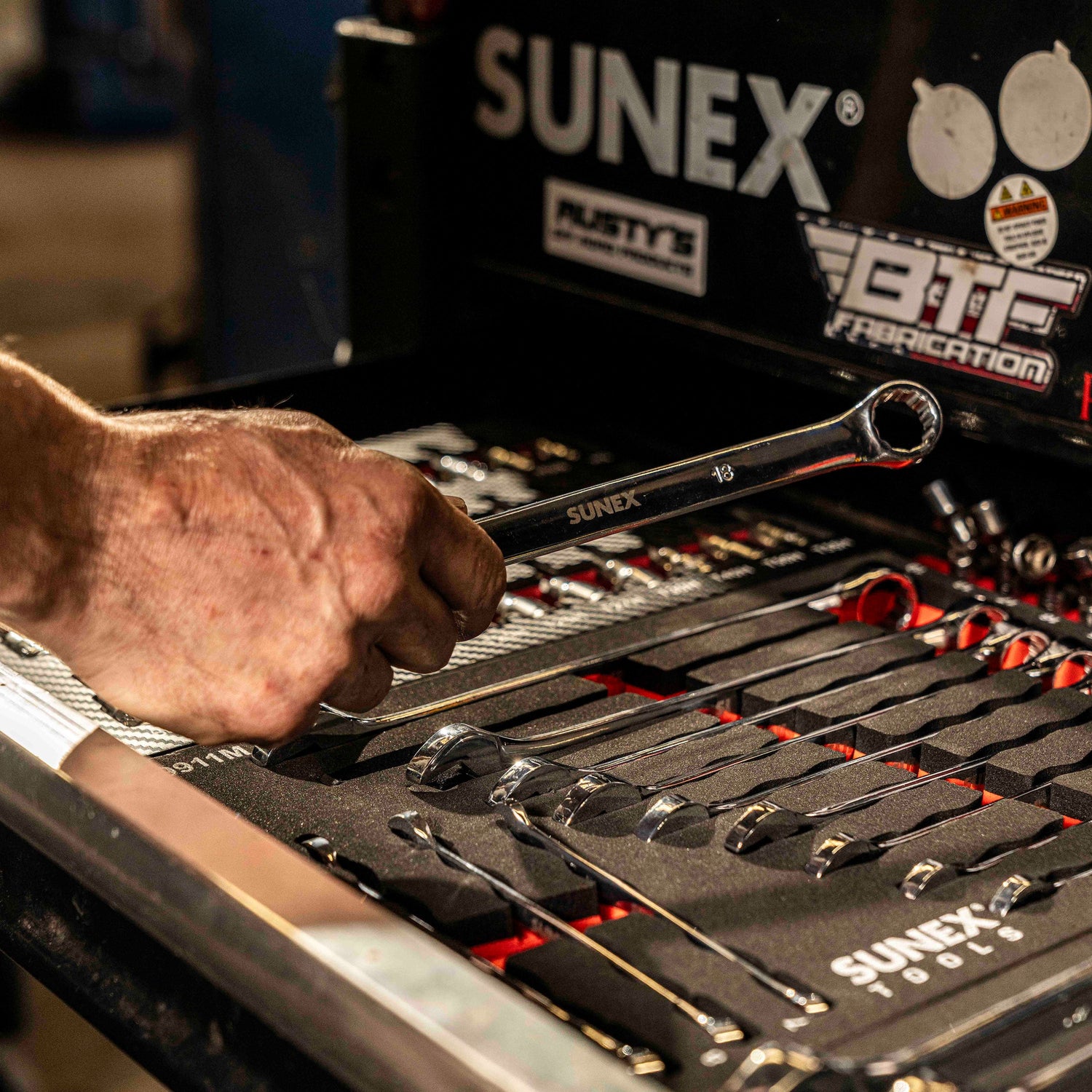 SUNEX Combination Wrench being removed from set and SUNEX Tool Box by technician