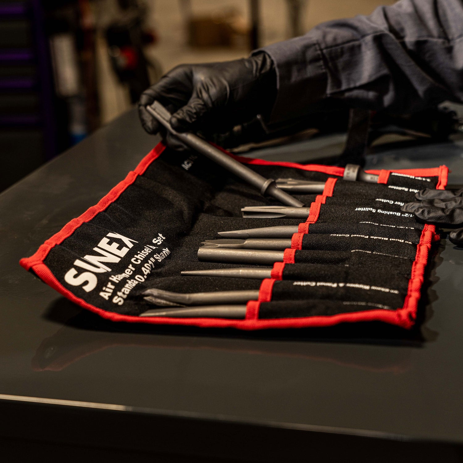 ACS10 10 Piece Air Chisel Set with technician removing of the pieces from the storage roll