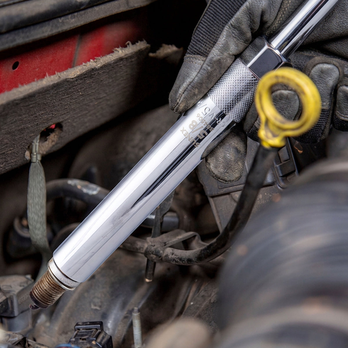 Spark Plug Socket being used by a technician in an engine bay.