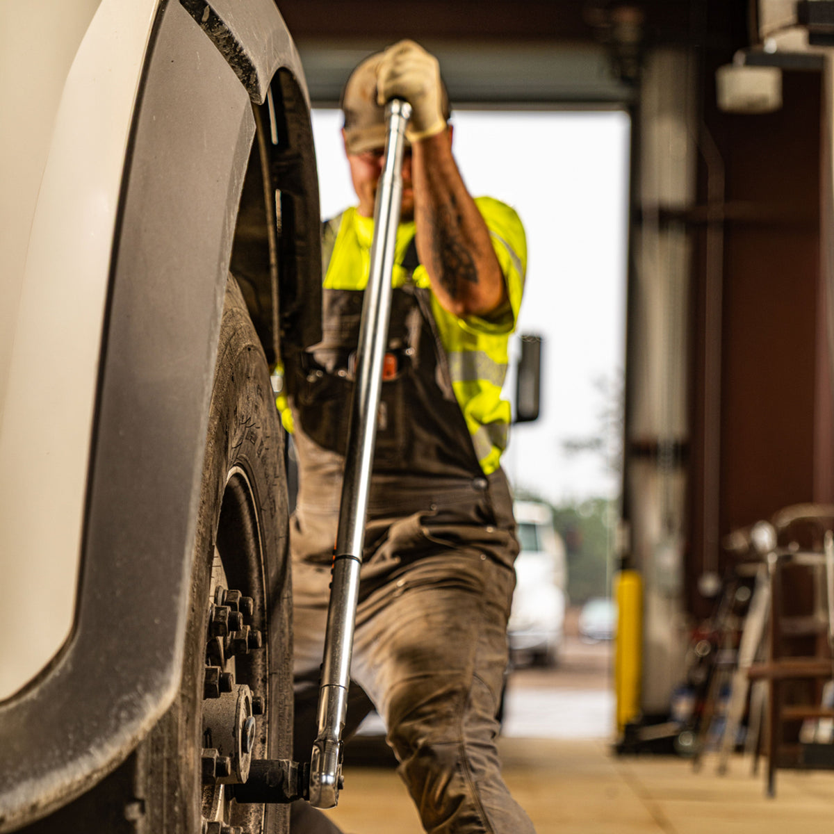 A Heavy-Duty Technician using a 3/4" Torque Wrench on a Heavy-Duty Truck and its wheels.