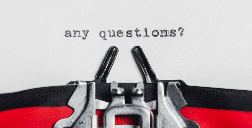 SUNEX Frequently Asked Questions with the words "any questions?" typed using a typewriter with black and red ribbon