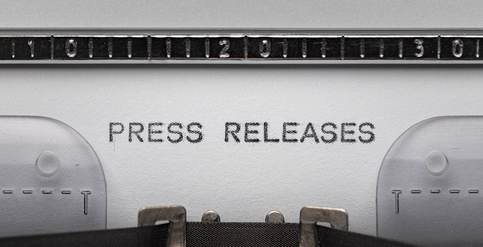 Press Releases typed on typewriter with paper