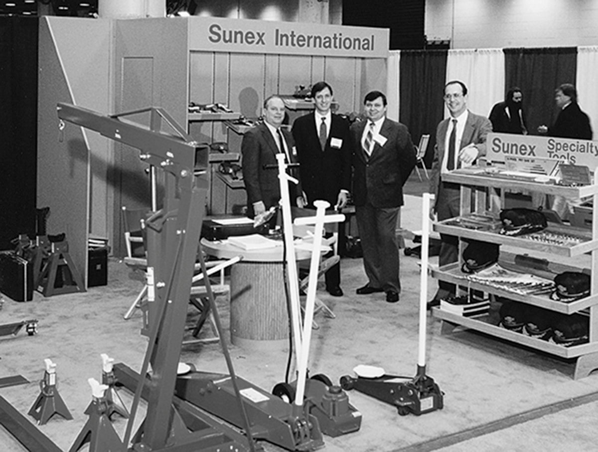 SUNEX International Team from 1977 at an automotive tools trade show surrounded by SUNEX Tools