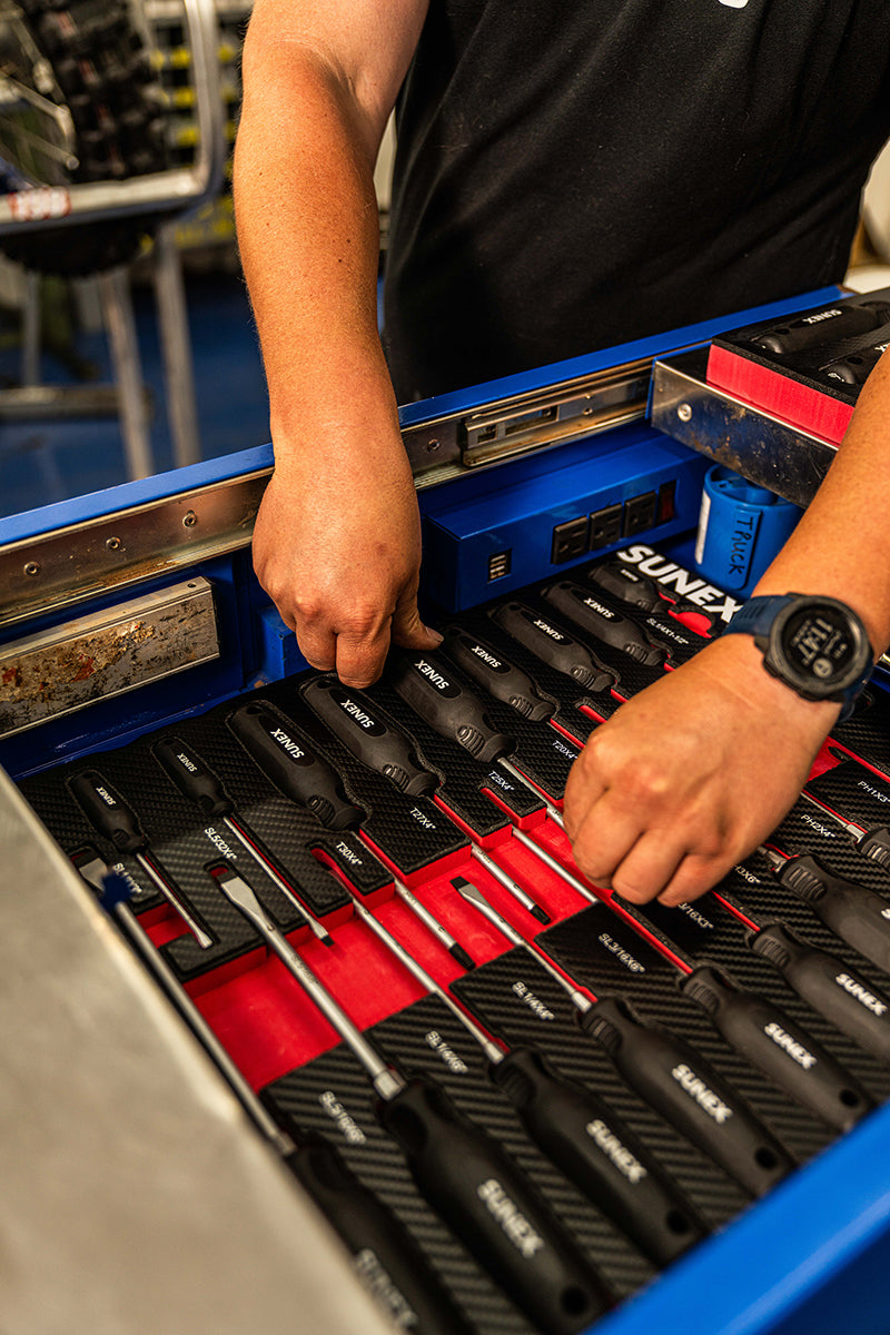 Technician organizing SUNEX Screwdrivers in a toolbox